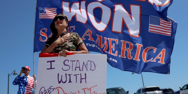 PALM BEACH, FLORIDA - MARCH 21: Cindy Falco-DiCarrado along with other people show their support for former President Donald Trump near his Mar-a-Lago home on March 21, 2023 in Palm Beach, Florida.