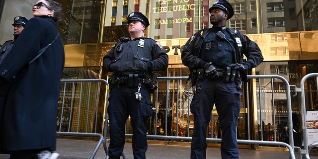 NYPD officers set up step barricades  outside Trump Tower on March 21, 2023, in New York City. 