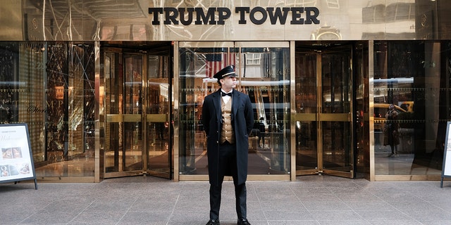 A doorman stands outside of Trump Tower in Manhattan ahead of a possible indictment against former president Donald Trump by the Manhattan District Attorney Alvin Bragg's office on March 22, 2023, in New York City. 