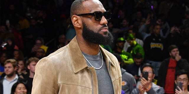 Injured LeBron James watches his Lakers take on the Phoenix Suns at Crypto.com Arena on March 22, 2023, in Los Angeles.