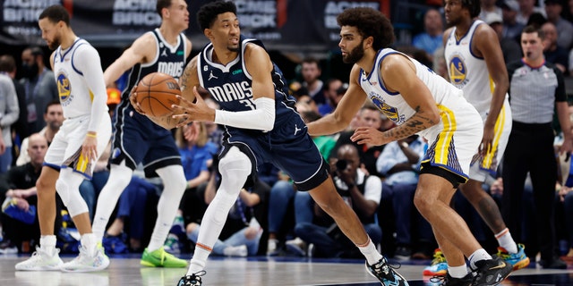 Christian Wood #35 of the Dallas Mavericks is guarded by Anthony Lamb #40 of the Golden State Warriors in the first half at American Airlines Center on March 22, 2023 in Dallas, Texas. Texas.