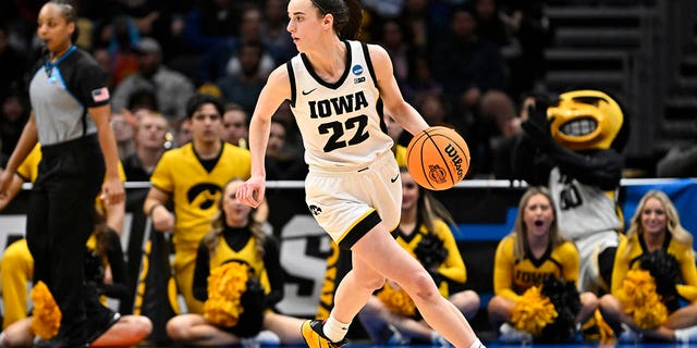 Caitlin Clark, #22 of the Iowa Hawkeyes, dribbles the ball against the Louisville Cardinals during the fourth quarter in the Elite Eight round of the NCAA Women's Basketball Tournament at Climate Pledge Arena on March 26, 2023 in Seattle.