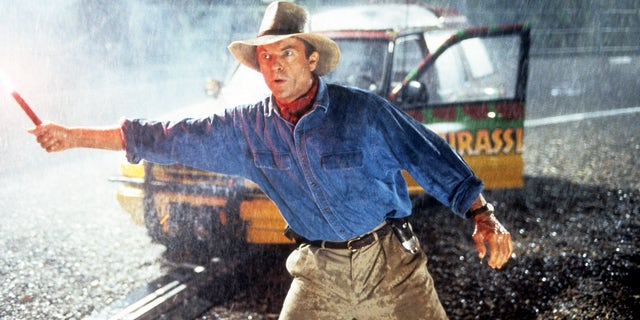 Neill holds a flare in a scene from the 1993 film "Jurassic Park."