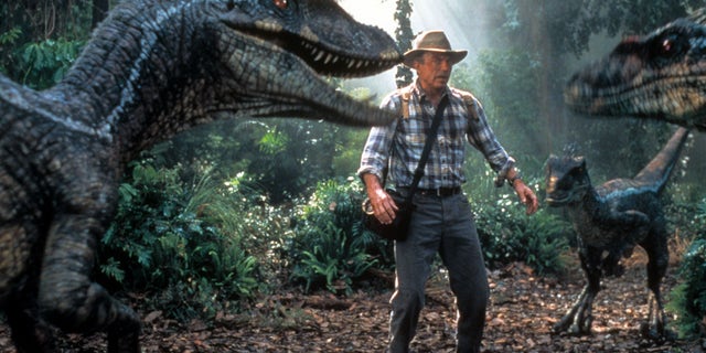 Neill is confronted by three dinosaurs in a scene from the 2001 film "Jurassic Park III."