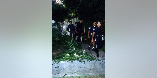 Police investigators look over the crime scene at the Brentwood condo after the bodies of Nicole Brown Simpson and Ron Goldman were found on June 13, 1994, in Brentwood, California.
