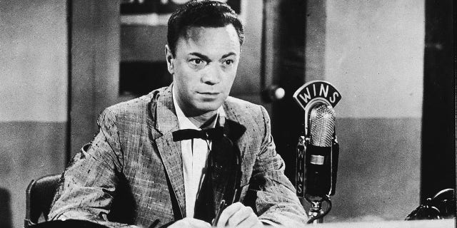American disc jockey and radio performer Alan Freed (1921-1965), who popularized the term rock 'n' roll, sits in a 1010 WINS sound studio during a radio broadcast, 1950s.