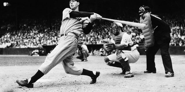 Joe DiMaggio is pictured as he smashed out his second homer in the first game of the Yankees double header with the Philadelphia Athletics. Joe and the other Yankee sluggers made baseball history when they clouted out eight four-baggers in the first game and five in the second game, breaking all existing home run records.