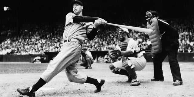 (Original Caption) 6/28/1939: Philadelphia, Pennsylvania: Joe DiMaggio is pictured as he smashed out his second homer in the first game of the Yankees double header with the Philadelphia Athletics. Joe and the other Yankee sluggers made baseball history when they clouted out eight four-baggers in the first game and five in the second game, breaking all existing home run records. Hayes is catching. Acme photograph.