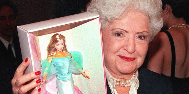 Ruth Handler holds a Barbie doll box at press conference