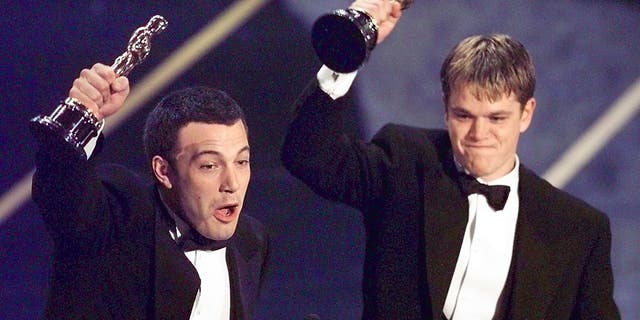 Ben Affleck and Matt Damon hold their Oscars on stage