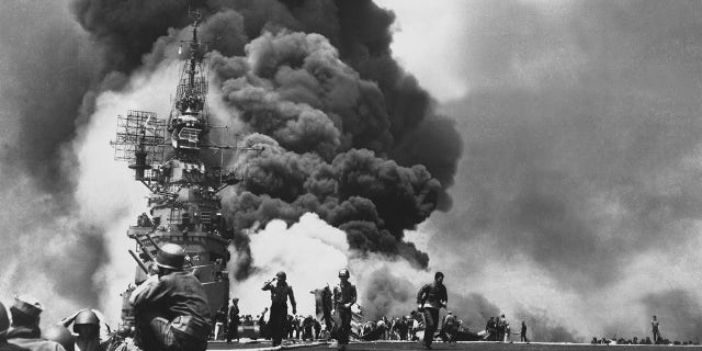 USS Bunker Hill is hit by two kamikaze pilots during the Battle of Okinawa, Japan 1945.