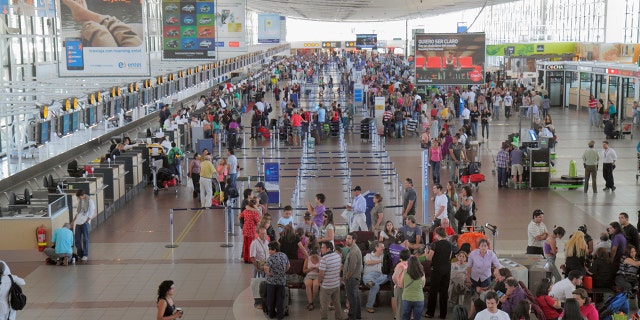 Travelers at Arturo Merino BenÍtez International Airport, where an attempted heist Wednesday left a security officer and an assailant dead.