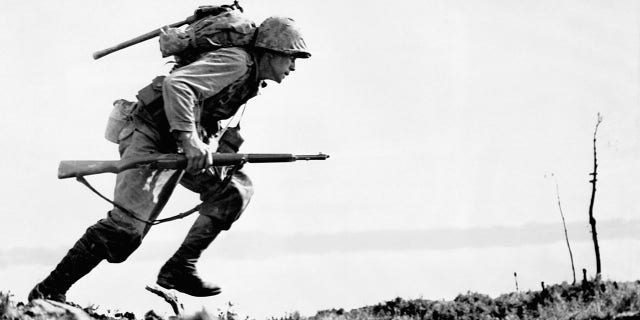 A U.S. Marine charges forward through Japanese machine gunfire on Okinawa. Marines and infantry of the U.S. 10th Army controlled three-quarters of Okinawa three weeks after landing on the island.