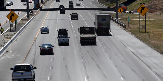 A view of a car trying to pass slow drivers in the left lane of Interstate 95 southbound in Baltimore, Maryland.