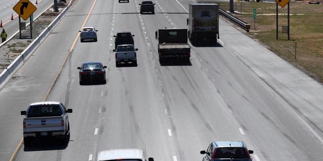 A view of a car trying to pass slow drivers in the left lane of Interstate 95 southbound in Baltimore, Maryland.