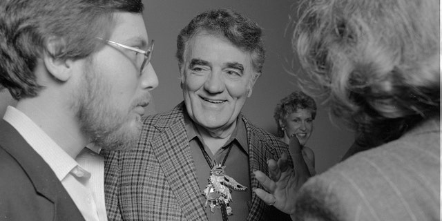 Author Louis L'Amour (center) is shown with guests at a party hosted by his publisher, Bantam Books, in Los Angeles. L'Amour wrote over 100 books during his lifetime. He thought of himself, he said, "in the oral tradition — as a troubadour, a village taleteller, the man in the shadows of the campfire."