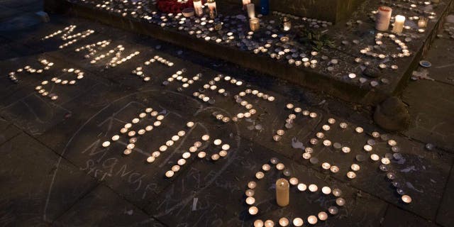 Memorial candles are seen during a vigil on St Ann's Square in Manchester, northwest England on May 29, 2017, exactly one week after a bomb attack at Manchester Arena killed 22 and injured dozens more. The attack, which has been claimed by an Islamic State jihadist group, targeted concertgoers at the end of a show by U.S. teen pop idol Ariana Grande.