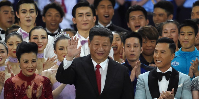 Oscars petitioned to revoke 'John Wick' star Donnie Yen's invitation over pro-China sentiments 3 China's President Xi Jinping (C) waves as he stands onstage with Hong Kong performer Lisa Wang (L) and actor Donnie Yen (R) as Xi joins performers at the end of a variety show in Hong Kong on June 30, 2017.