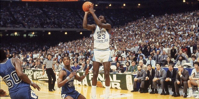 NCAA Final Four, North Carolina Michael Jordan (#23) in action, making game-winning shot vs. Georgetown, New Orleans, March 29, 1982. The term "March Madness" began to gain recognition at the collegiate level that year. 