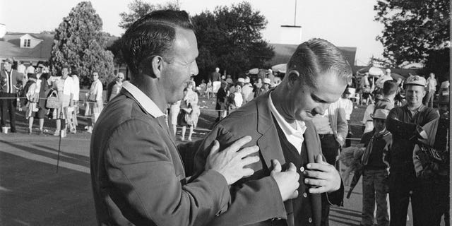 Arnold Palmer, left, helping victorious Jack Nicklaus with green blazer at Augusta National Golf Course, Augusta, Georgia, April 7, 1963. 