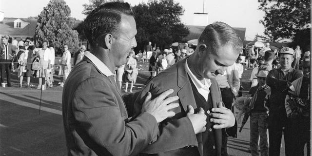 Arnold Palmer, left, helping victorious Jack Nicklaus with green blazer at Augusta National Golf Course, Augusta, Georgia, April 7, 1963.Â