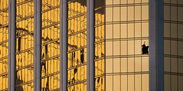 A window is broken on the 32nd floor of the Mandalay Bay Resort and Casino where a gunman opened fire on a concert crowd on Sunday night, Oct. 3, 2017 in Las Vegas. 