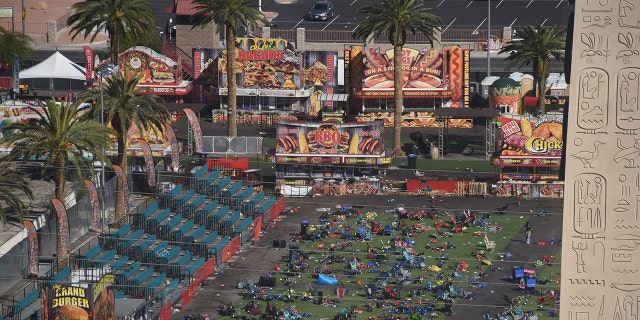 FILE - Personal belongings are gathered on the ground at the venue of the Route 91 Harvest Festival venue where FBI investigators continued work in the aftermath of the worst modern mass murder in U.S. history in Las Vegas, on Oct. 4, 2017.