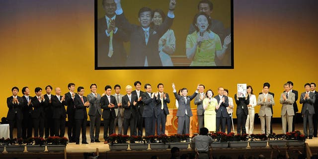 Ryuho Okawa, leader of religious corporation "Happy Science," waves to supporters during their west Tokyo meeting at Chofu City Green Hall on July 22, 2009 in Tokyo. Okawa announced his candidacy for the lower house election from The Happiness Realization Party.