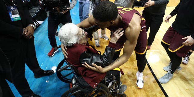 Aundre Jackson (24) of the Loyola Ramblers celebrates with Sister Jean Dolores Schmidt after defeating the Nevada Wolf Pack during the 2018 NCAA men's basketball tournament South regional at Philips Arena March 22, 2018, in Atlanta.