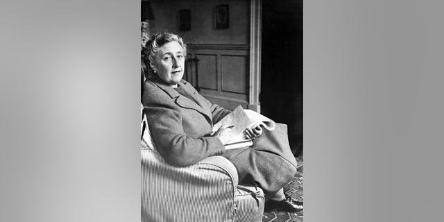 English writer Lady Agatha Christie, in March 1946, poses for a photographer holding a notebook, at her home, Greenway House, in Devonshire. 