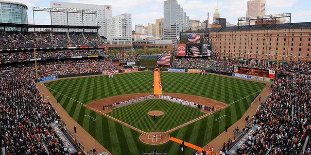 The Baltimore Orioles and the Toronto Blue Jays line up for the national anthem on Opening Day at Camden Yards on April 9, 2010 in Baltimore.