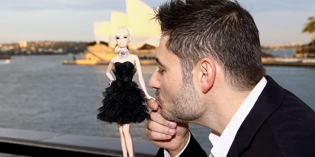 Jewelry designer Stefano Canturi poses with the world's most expensive Barbie doll at the Barbie Basics Collection Launch during Rosemount Australian Fashion Week Spring/Summer 2010-2011 at the Overseas Passenger Terminal at Circular Quay on May 4, 2010, in Sydney, Australia. Barbie, with real diamonds, netted $302,500 in auction. 