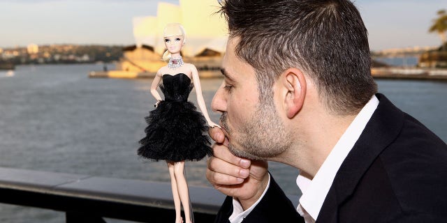 Jewelry designer Stefano Canturi poses with the world's most expensive Barbie doll at the Barbie Basics Collection Launch during Rosemount Australian Fashion Week Spring/Summer 2010-2011 at the Overseas Passenger Terminal at Circular Quay on May 4, 2010, in Sydney, Australia. Barbie, with real diamonds, netted $302,500 in auction.