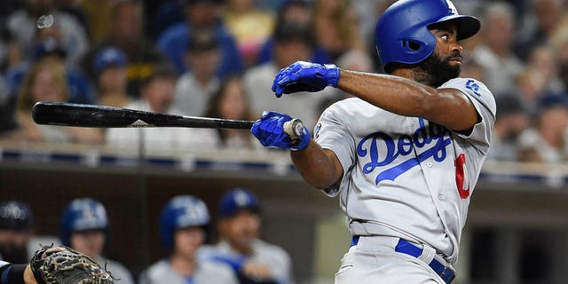 Andrew Toles of the Los Angeles Dodgers hits an RBI single during the seventh inning of a game against the San Diego Padres at PETCO Park on July 12, 2018 in San Diego. 