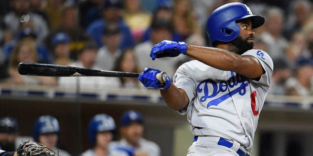 Andrew Toles of the Los Angeles Dodgers hits an RBI single during the seventh inning of a game against the San Diego Padres at PETCO Park on July 12, 2018 in San Diego. 