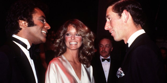 Then Prince Charles, right, is seen here in 1978 meeting singer Johnny Mathis, left, and Farrah Fawcett backstage at The London Palladium.