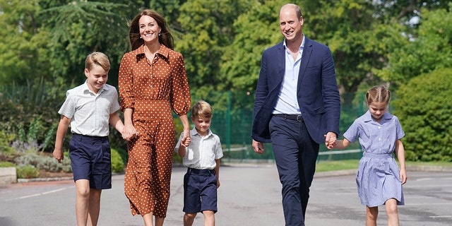 Prince George, left, Princess Charlotte, right, and Prince Louis, middle, accompanied by their parents, the Prince and Princess of Wales, on their way to school in 2022.