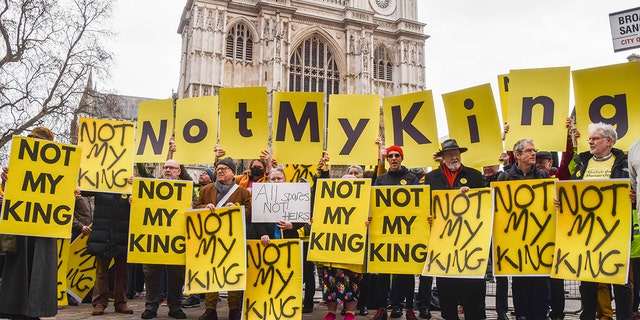 Anti-monarchy protesters hold placards reading 'Not My King' during the demonstration outside Westminster Abbey, as King Charles III and other members of the royal family arrive for the Commonwealth Day Service.