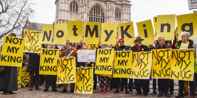 Anti-monarchy protesters hold placards reading 'Not My King' during the demonstration outside Westminster Abbey, as King Charles III and other members of the royal family arrive for the Commonwealth Day Service.