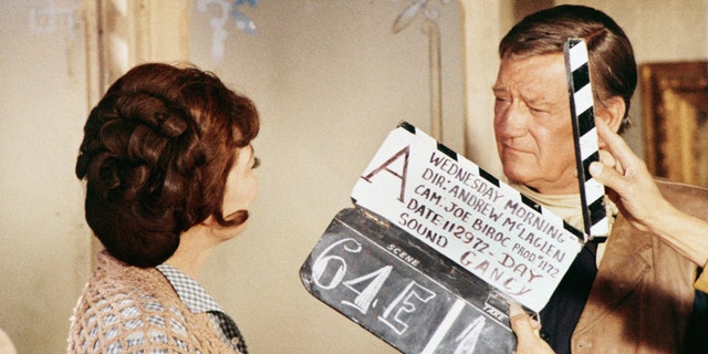 John Wayne and Marie Windsor on the set of "Cahill U.S. Marshal," directed by Andrew V. McLaglen, on Nov. 29, 1972, in Los Angeles, California.