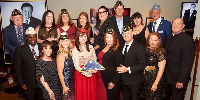Dee Dee Sorvino, bottom-middle right, and the American Legion Post 43 pose for a picture at Paul Sorvino's Celebration Of Life at The Hollywood Museum on Aug. 17, 2022, in Hollywood, California.