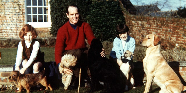 Sarah Ferguson, the Duchess of York, left, with her sister Jane, and their father, Major Ronald Ferguson, at Dummer Down House. With them are their dogs Kerry, Puffy, Tweed, Tigger and George. 