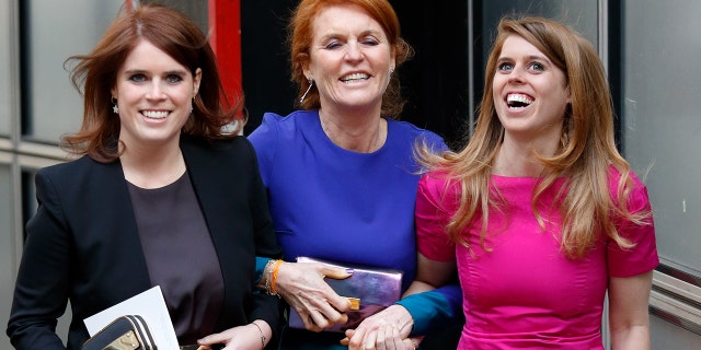 Sarah Ferguson holding onto her two daughters