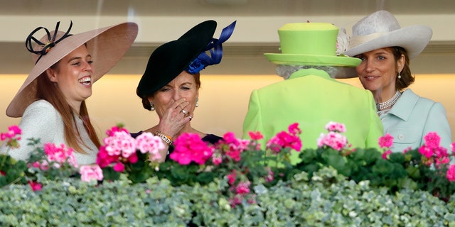 From left: Princess Beatrice; Sarah, Duchess of York; and Lady Carolyn Warren walk with Queen Elizabeth II in the Royal Box before watching the queen's horse Elector run in the King Edward VII stakes on day four of Royal Ascot at Ascot Racecourse June 22, 2018, in Ascot, England. 