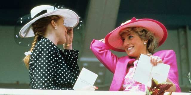 Sarah Ferguson and Princess Diana laughing at each other during the Epsom Derby Match