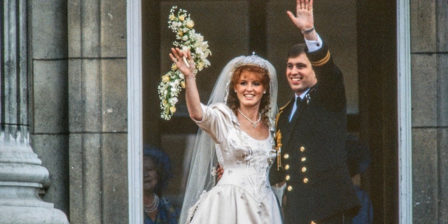 Just married couple Sarah, Duchess of York, and Prince Andrew, Duke of York, wave from the balcony of Buckingham Palace in London on July 23, 1986.