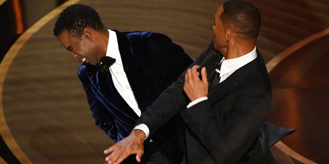 Will Smith is seen here slapping Chris Rock onstage during the 94th Oscars at the Dolby Theatre in Hollywood, California on March 27, 2022.