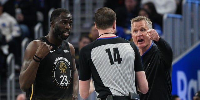 Golden State Warriors head coach Steve Kerr and Draymond Green #23 share words with referee Ed Malloy during the second quarter against the New Orleans Pelicans at Chase Center on March 28, 2023 in San Francisco, California.