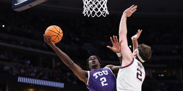 TCU Horned Frogs' Emanuel Miller #2 drives to the basket against Gonzaga Bulldogs' Drew Timme #2 during the second half of the second round of the NCAA Men's Basketball Tournament at Ball Arena on March 19, 2023 in Denver, Colorado.