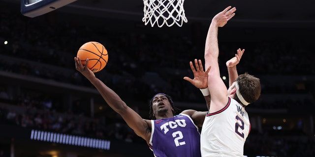 Emanuel Miller #2 of the TCU Horned Frogs drives to the basket against Drew Timme #2 of the Gonzaga Bulldogs during the second half in the second round of the NCAA Men's Basketball Tournament at Ball Arena on March 19, 2023 in Denver, Colorado.